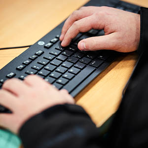 close up of person using a computer keyboard