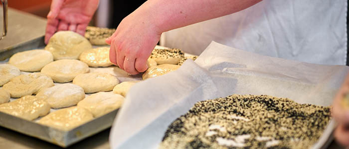 close up of students baking bread