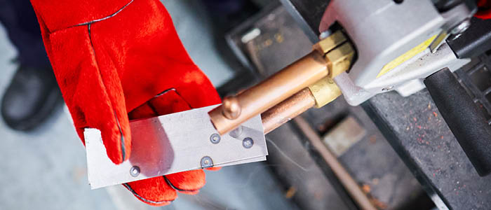 student doing a spot weld