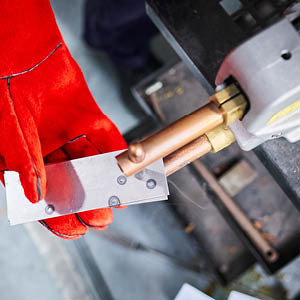 student doing a spot weld