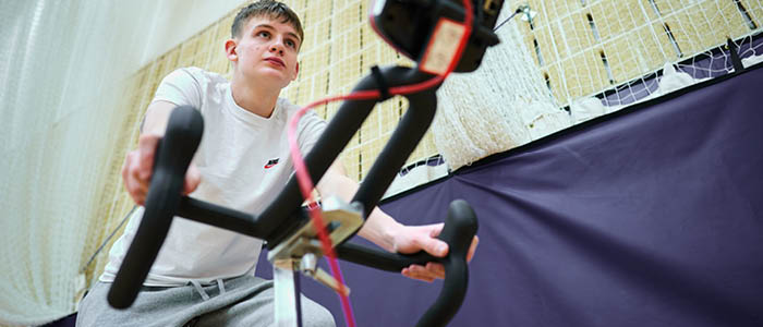 student on an exercise bike