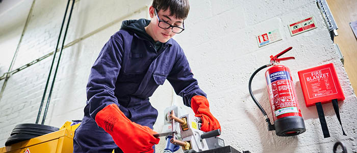 student doing a spot weld