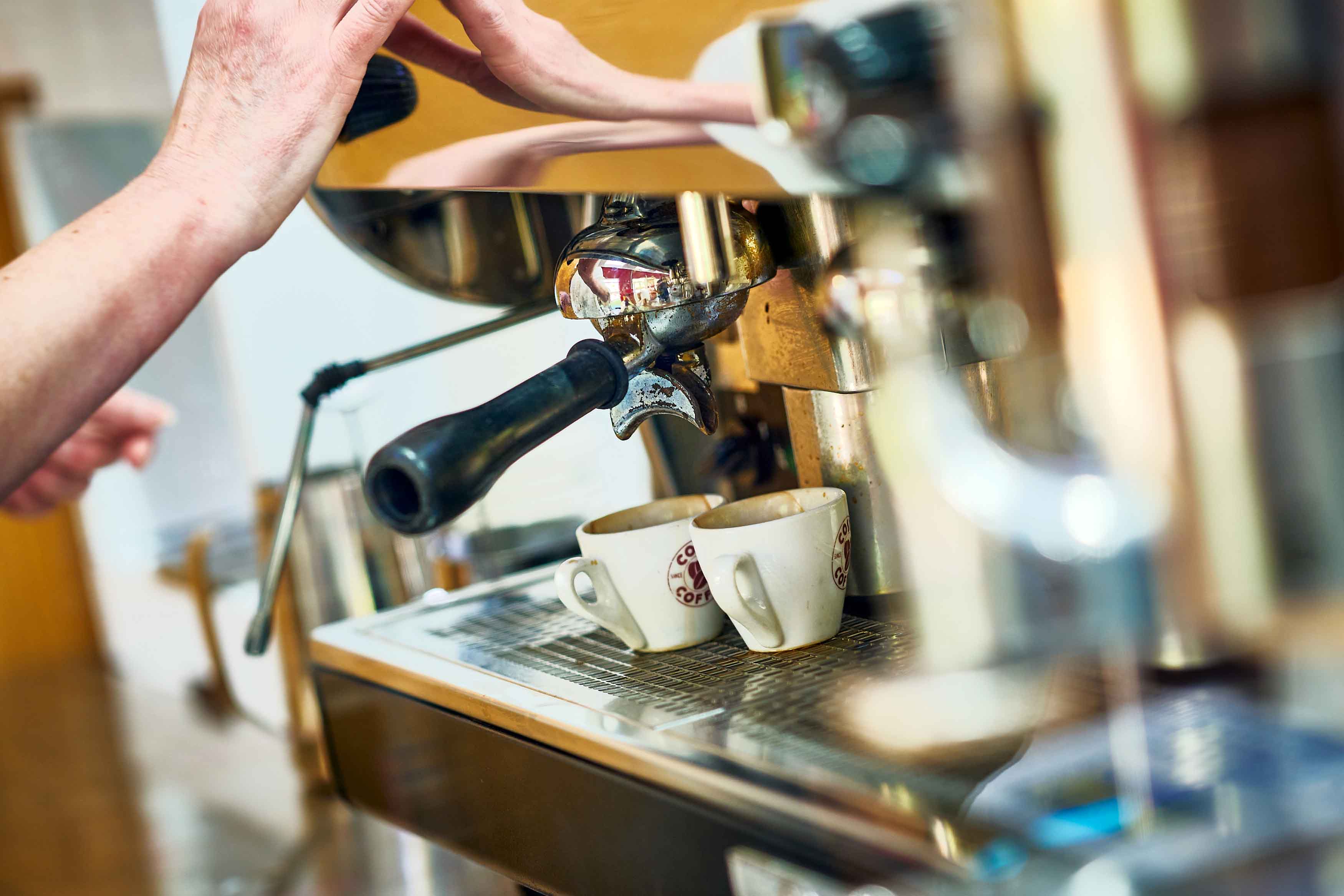 close up of coffee being made from machine