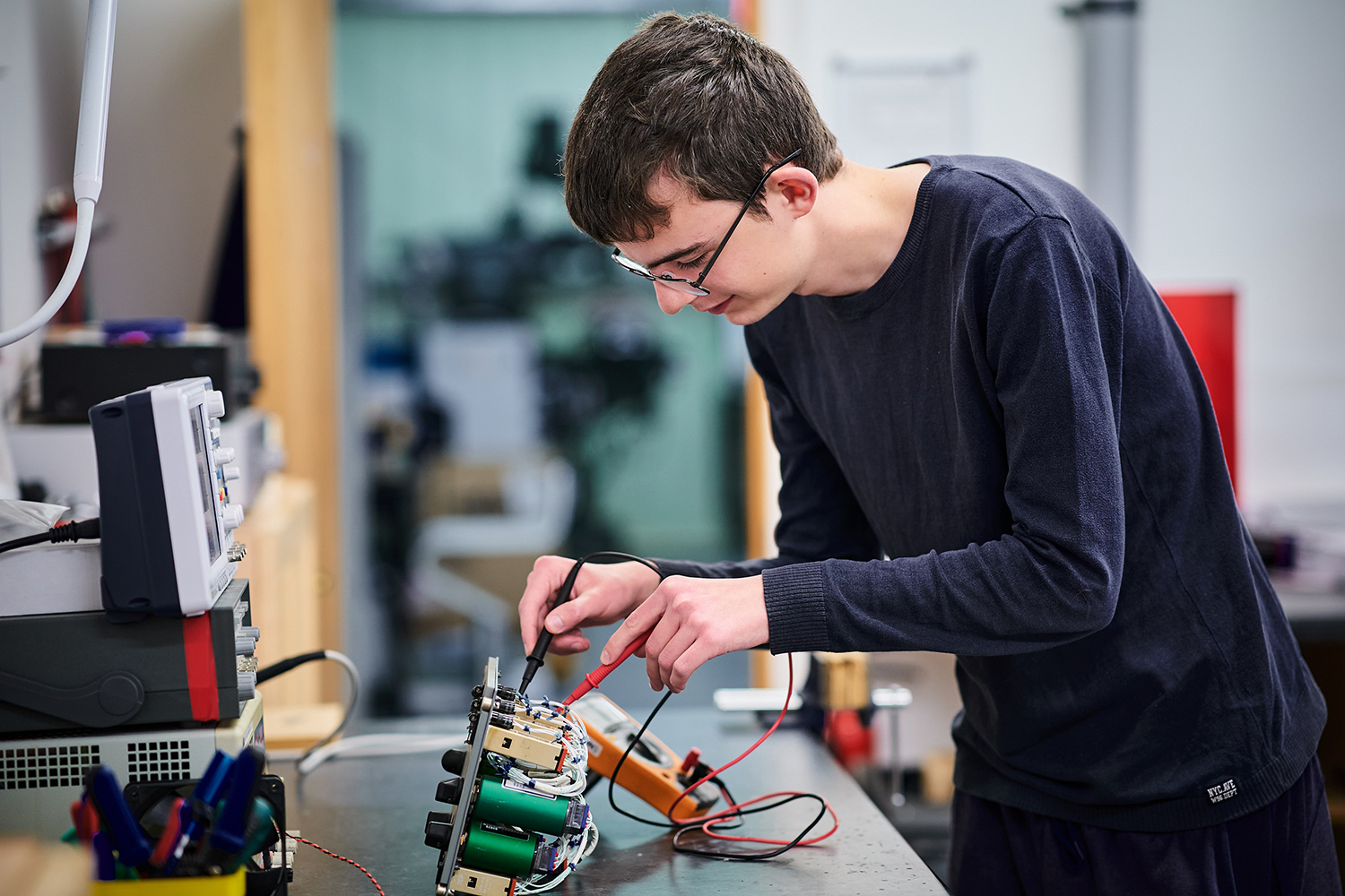 student working on an aircraft part