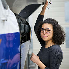 erica standing next to a plane