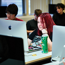 a creative industries student working on a computer