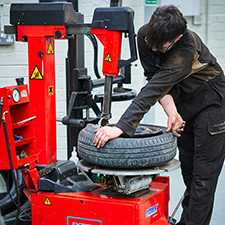 student fixing a tyre