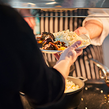 chef serving food in food court