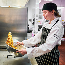 chef preparing chips in a bowl