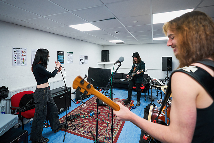 students performing in a rehearsal room